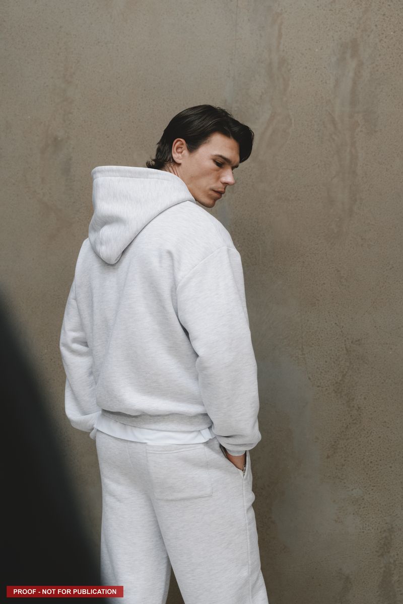 A relaxed portrait against the studio's plaster wall.